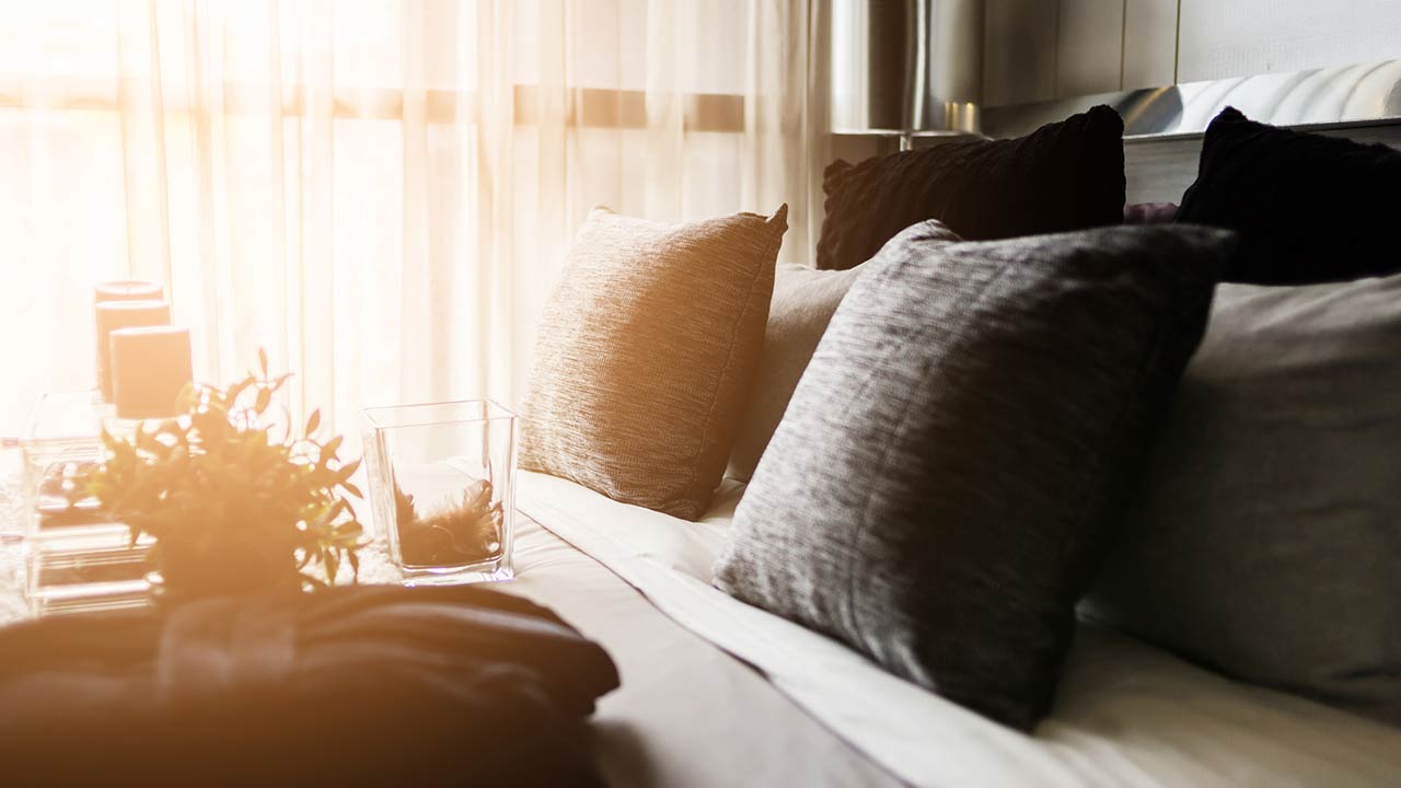 Photo of a bed maid-up with clean white pillows and bed sheets in beauty room