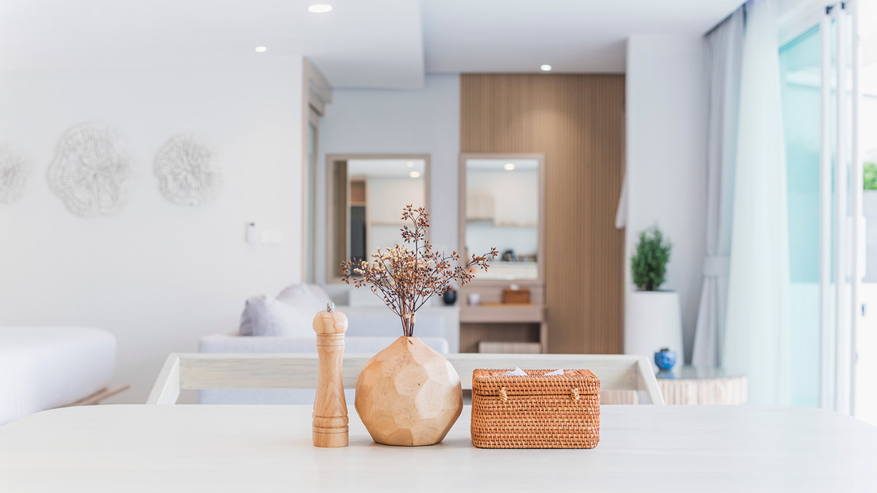 Modern kitchen interior, wooden table, blurred background showing the atmosphere of the room, clean design, home cooking area, neutral colors, natural light stock photo
